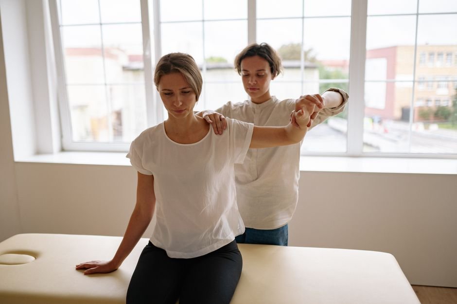 Therapist guiding a patient through a stretching session at one of the top universities in USA for physical therapy
